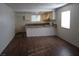Open living space showcasing wood floors and seamless flow into the bright kitchen at 4451 Rich Dr # D, Las Vegas, NV 89102