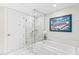 Elegant bathroom with marble tiling, glass-enclosed shower, and soaking tub with a Las Vegas sign at 4471 Dean Martin Dr # 1707, Las Vegas, NV 89103
