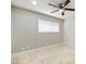 A well-lit bedroom with tile flooring, ceiling fan and a window at 4676 E Alexander Rd, Las Vegas, NV 89115