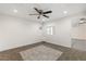 This room has a ceiling fan, neutral walls, and a window for natural light at 4676 E Alexander Rd, Las Vegas, NV 89115