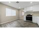 Well-lit kitchen featuring stainless steel appliances, white cabinets, and wood-look flooring at 4676 E Alexander Rd, Las Vegas, NV 89115