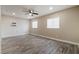 Large living room with light gray hard wood flooring, ceiling fan, and recessed lights at 4676 E Alexander Rd, Las Vegas, NV 89115