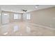 Spacious living room featuring neutral walls, ceiling fan, and marble tile flooring at 4676 E Alexander Rd, Las Vegas, NV 89115