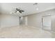 Spacious living room featuring neutral walls, ceiling fan, and marble tile flooring at 4676 E Alexander Rd, Las Vegas, NV 89115