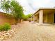 Enjoy a private backyard oasis with a covered patio, mature trees, and gravel landscaping at 4717 Mohawk River Ave, North Las Vegas, NV 89031