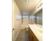 Well-lit bathroom featuring a double sink vanity and shower-tub combination at 4717 Mohawk River Ave, North Las Vegas, NV 89031