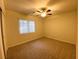 Cozy bedroom with neutral walls, carpeted flooring, and a ceiling fan for comfort at 4717 Mohawk River Ave, North Las Vegas, NV 89031