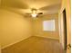 Bright bedroom featuring a ceiling fan, carpeted flooring, and a window for natural light at 4717 Mohawk River Ave, North Las Vegas, NV 89031