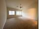 Carpeted bedroom with ceiling fan and bay windows at 4717 Mohawk River Ave, North Las Vegas, NV 89031