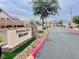 View of the community entrance sign with red accents and manicured landscape at 4717 Mohawk River Ave, North Las Vegas, NV 89031