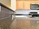 Kitchen sink with stainless steel faucet and granite countertops with stainless steel oven and microwave in background at 4717 Mohawk River Ave, North Las Vegas, NV 89031