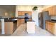 Well-lit kitchen with stainless steel appliances, spacious countertops and island, perfect for cooking and entertaining at 4717 Mohawk River Ave, North Las Vegas, NV 89031