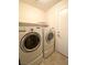 Laundry room with updated appliances and storage shelf at 4717 Mohawk River Ave, North Las Vegas, NV 89031
