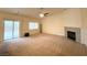 Spacious living room with cozy fireplace and access to the outdoor area with sliding glass doors at 4717 Mohawk River Ave, North Las Vegas, NV 89031
