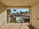 Balcony view of a community pool surrounded by lush greenery and well-maintained buildings under a clear, sunny sky at 4805 Nara Vista Way # 203, Las Vegas, NV 89103