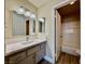 Well-lit bathroom features modern vanity, updated fixtures, and a shower/tub combo with tiled surround at 4805 Nara Vista Way # 203, Las Vegas, NV 89103