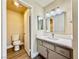 Bathroom with a white vanity, a large mirror, and a toilet; open doorway leads to a linen closet at 4805 Nara Vista Way # 203, Las Vegas, NV 89103