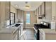 Well-lit kitchen features stainless steel appliances, modern cabinetry, mosaic tile backsplash, and bright quartz countertops at 4805 Nara Vista Way # 203, Las Vegas, NV 89103