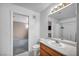 This bathroom includes a toilet, sink, mirror and shower at 5024 Starfinder Ave, Las Vegas, NV 89108