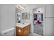 Cozy bathroom with vanity, toilet, and view into bedroom with mounted television at 5024 Starfinder Ave, Las Vegas, NV 89108