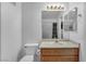 A bright bathroom featuring a toilet, sink, mirror and shower at 5024 Starfinder Ave, Las Vegas, NV 89108
