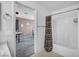 Clean bathroom featuring a shower-tub, access to another room, and neutral colors at 5024 Starfinder Ave, Las Vegas, NV 89108