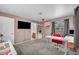Spacious bedroom area featuring carpeted floors, a window, and a mounted television at 5024 Starfinder Ave, Las Vegas, NV 89108
