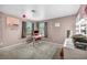 Carpeted bedroom with two windows, gray curtains, and a dedicated vanity area at 5024 Starfinder Ave, Las Vegas, NV 89108