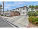 A mediterranean-style townhouse featuring a driveway, parking area, and lush landscaping at 5024 Starfinder Ave, Las Vegas, NV 89108
