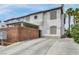 Two-story condo with desert landscaping, brick wall, and driveway under a carport at 5024 Starfinder Ave, Las Vegas, NV 89108