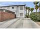 Mediterranean-style townhouse with driveway and lush palm tree landscaping at 5024 Starfinder Ave, Las Vegas, NV 89108