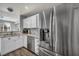 Stainless steel refrigerator in a kitchen with white cabinets and granite countertops at 5024 Starfinder Ave, Las Vegas, NV 89108