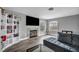 Relaxing living room with a fireplace, TV, plush couch, and a bookshelf at 5024 Starfinder Ave, Las Vegas, NV 89108