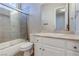 Bathroom features a shower-tub combo with glass doors and a vanity with a marble countertop at 5193 N Miller Ln, Las Vegas, NV 89149