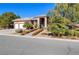 Single-story home displaying desert landscaping, a three-car garage, and a tile roof at 5193 N Miller Ln, Las Vegas, NV 89149