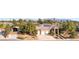 Sprawling single-story home featuring solar panels and manicured landscaping, with views of the mountains at 5193 N Miller Ln, Las Vegas, NV 89149