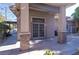 A covered exterior entrance is framed by stone columns and large glass doors at 5193 N Miller Ln, Las Vegas, NV 89149