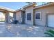 Exterior side view of home featuring neutral stucco, tile roof and access door at 5193 N Miller Ln, Las Vegas, NV 89149
