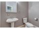 Neutral powder room with a pedestal sink and standard toilet at 5193 N Miller Ln, Las Vegas, NV 89149