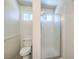 Clean bathroom with a modern glass shower, toilet and a small window at 520 Arrowhead Trl # 522, Henderson, NV 89015