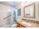 Bathroom with a granite countertop, white tile walls, and a themed shower curtain at 520 Arrowhead Trl # 522, Henderson, NV 89015