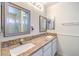 Bathroom featuring double sinks, granite countertops, framed mirrors and paneled walls at 520 Arrowhead Trl # 522, Henderson, NV 89015