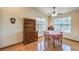 Dining area with hardwood floors, natural light, and a classic hutch at 520 Arrowhead Trl # 522, Henderson, NV 89015