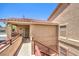 Condo entrance featuring a secure screen door and railed walkway at 520 Arrowhead Trl # 522, Henderson, NV 89015