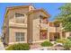 Exterior view of a two-story condo with a balcony and well-kept landscaping at 520 Arrowhead Trl # 522, Henderson, NV 89015