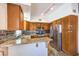 Well-equipped kitchen with granite countertops, stainless steel appliances and wooden cabinetry at 520 Arrowhead Trl # 522, Henderson, NV 89015