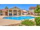 Community swimming pool with lounge area and surrounding landscaping at 520 Arrowhead Trl # 522, Henderson, NV 89015