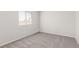This bedroom has a large window and plush carpet at 5402 Shady Lair Ct, North Las Vegas, NV 89031