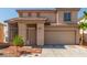Charming two-story home with a two-car garage, landscaped yard and neutral stucco exterior at 5402 Shady Lair Ct, North Las Vegas, NV 89031