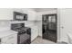 Modern kitchen with stainless steel appliances, white cabinets, and quartz countertops at 5402 Shady Lair Ct, North Las Vegas, NV 89031